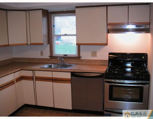 4705 Hana Road Edison, NJ 08817 - Photo 2 of 8 a kitchen with stainless steel appliances a stove a sink and a microwave