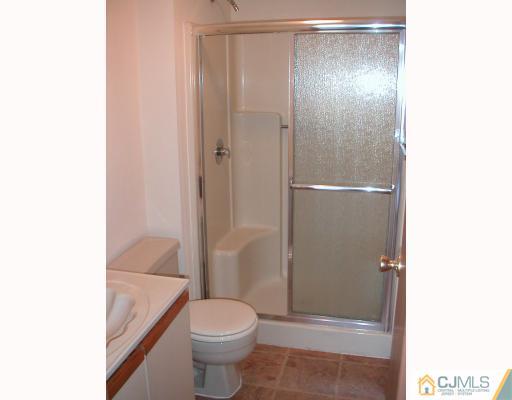 4705 Hana Road Edison, NJ 08817 - Photo 7 of 8 a bathroom with a granite countertop bathtub shower