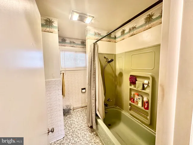a bathroom with a tub and shower