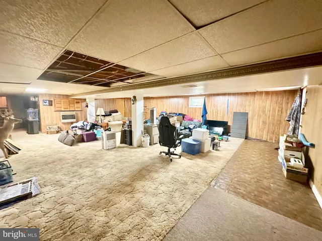 a living room with furniture and a mirror