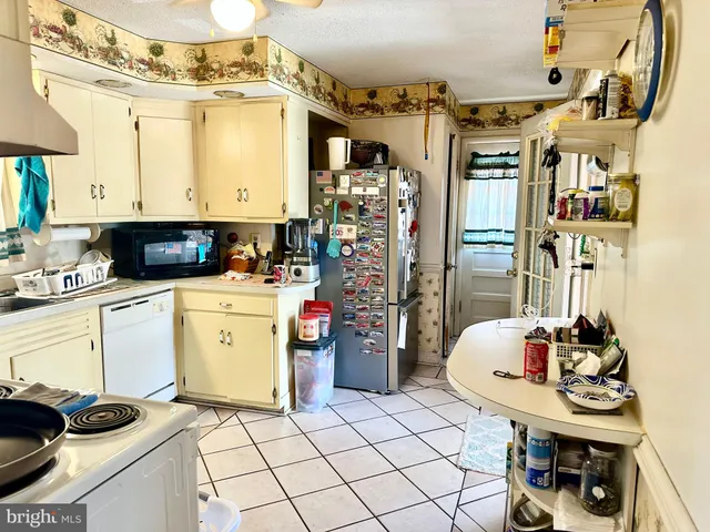 a kitchen with a sink appliances and cabinets