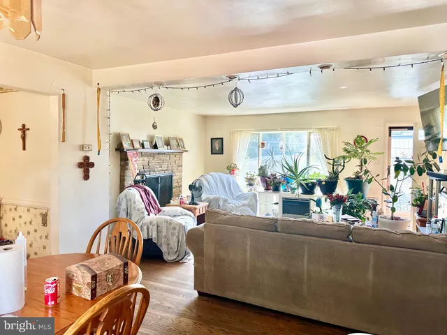 a living room with furniture and a large mirror