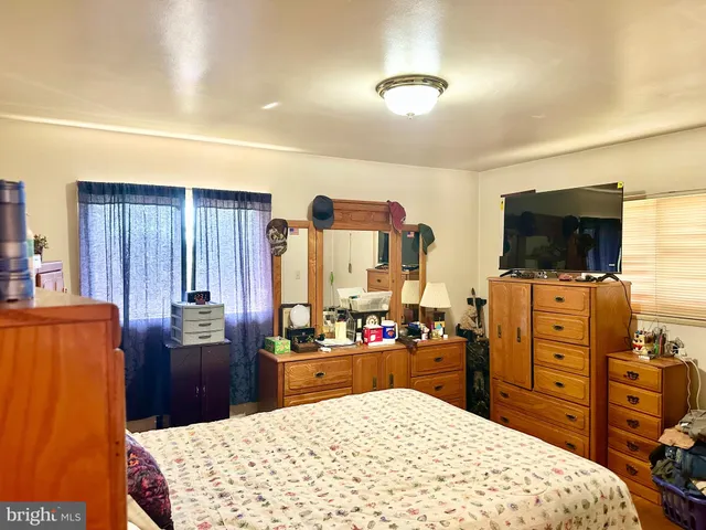 a bed room with a bed and a television