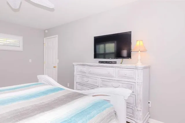 a bedroom with a bed and a flat screen tv