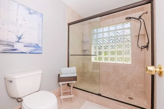 a white toilet sitting next to a bathroom sink