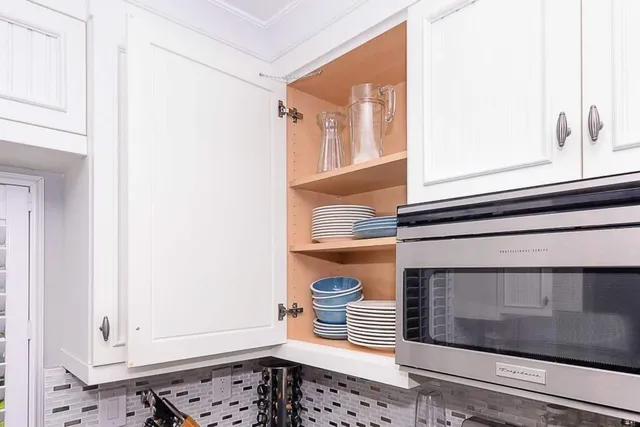 a front view of a house with white walls and a window