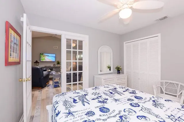 a bedroom with a bed and wooden floor