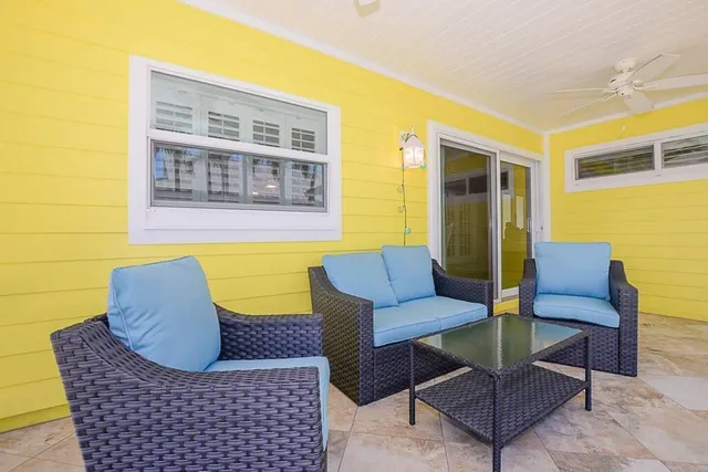 a balcony with furniture and a floor to ceiling window