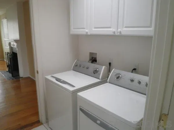 a kitchen with white cabinets and white appliances