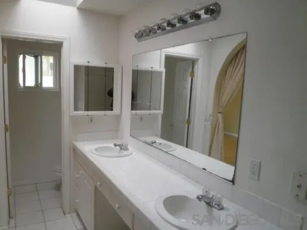 a kitchen with stainless steel appliances granite countertop a red stove top oven and a sink