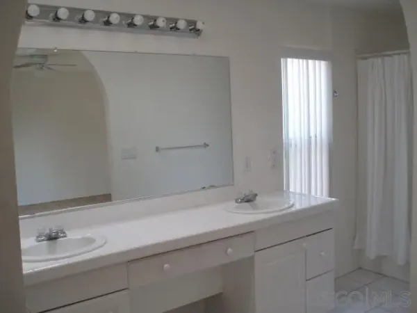 an empty room with cabinet and mirrors