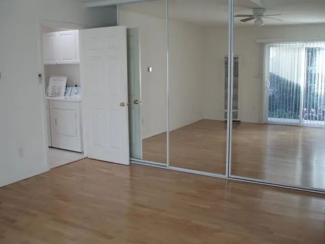 a view of a livingroom with wooden floor and a fireplace