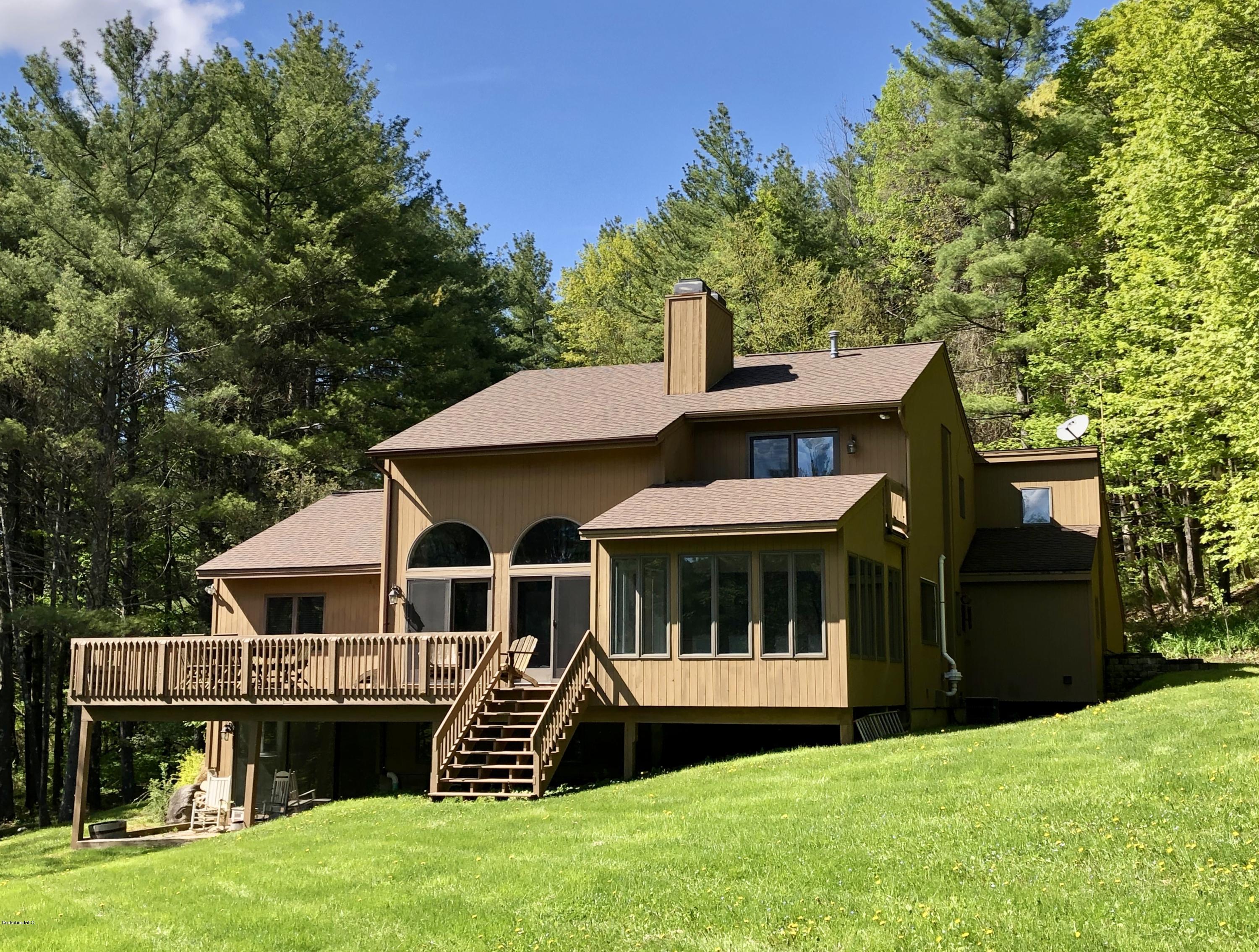 755 Tyringham Road Lee, MA 01238 - Photo 1 of 32 a front view of a house with a garden