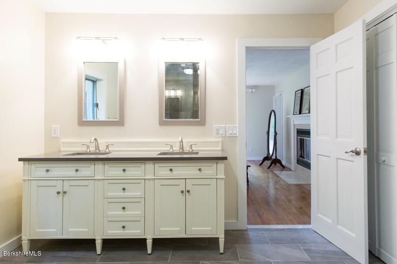755 Tyringham Road Lee, MA 01238 - Photo 21 of 32 a bathroom with a double vanity sink and mirror