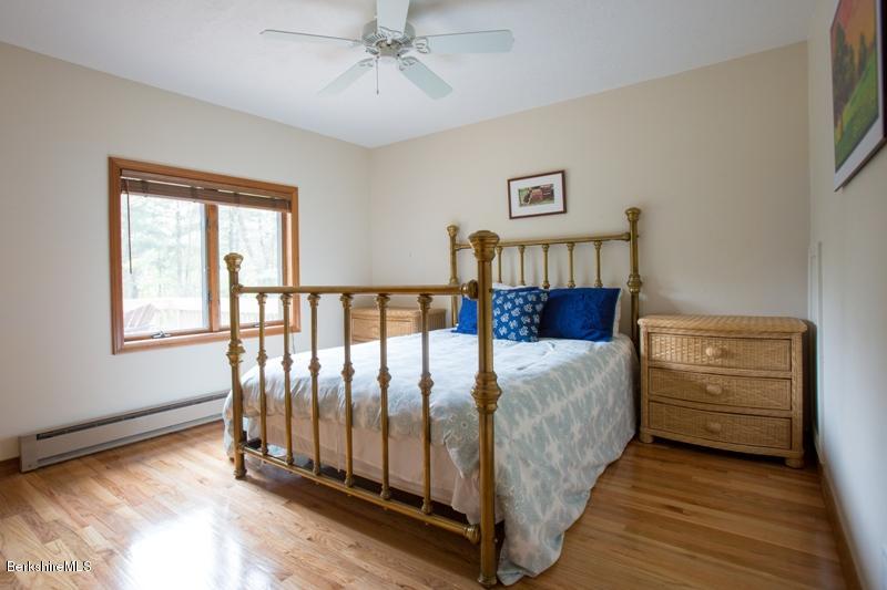 755 Tyringham Road Lee, MA 01238 - Photo 24 of 32 a bed sitting in a bedroom next to a window