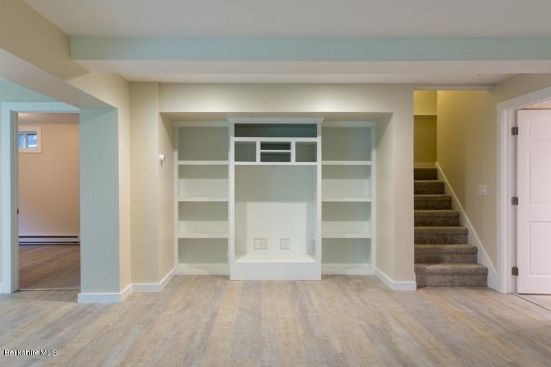 755 Tyringham Road Lee, MA 01238 - Photo 29 of 32 a view of an empty room with a fireplace and a window