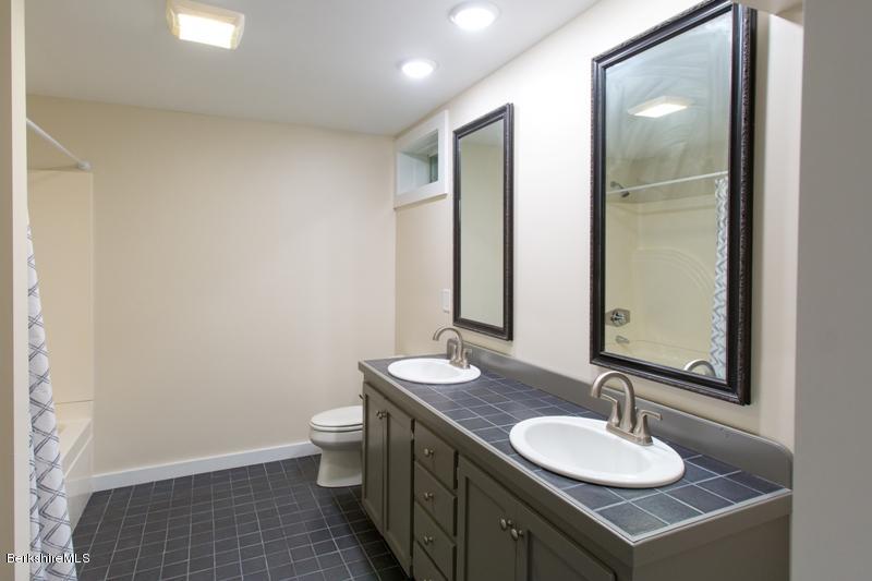 755 Tyringham Road Lee, MA 01238 - Photo 30 of 32 a bathroom with a sink and a mirror