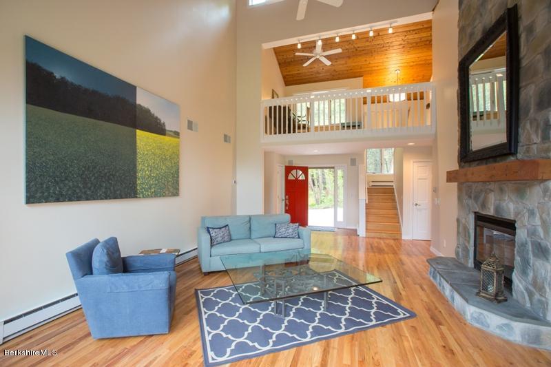 755 Tyringham Road Lee, MA 01238 - Photo 5 of 32 a living room with furniture and a flat screen tv