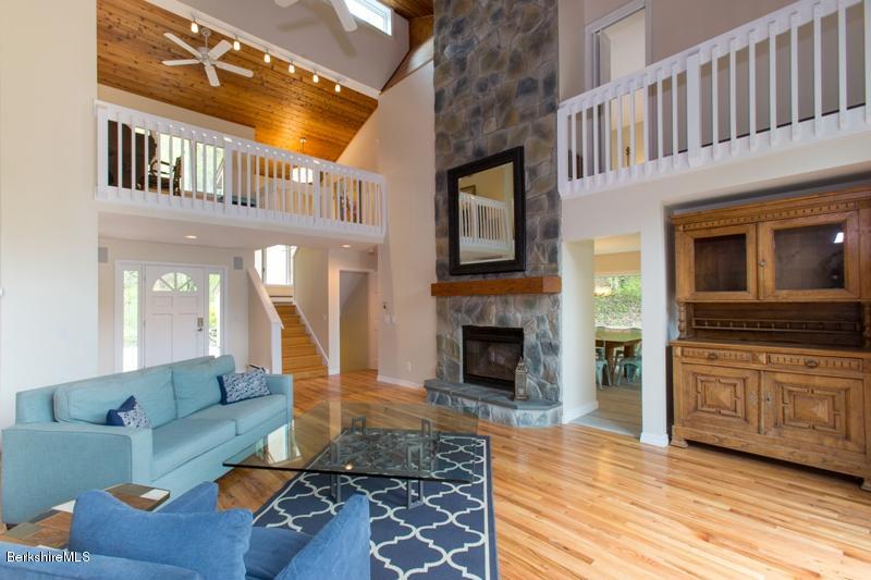 755 Tyringham Road Lee, MA 01238 - Photo 7 of 32 a living room with furniture a fireplace and a flat screen tv
