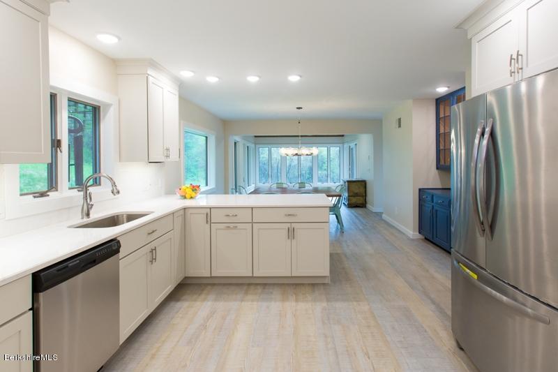 755 Tyringham Road Lee, MA 01238 - Photo 9 of 32 a large kitchen with a refrigerator and a sink