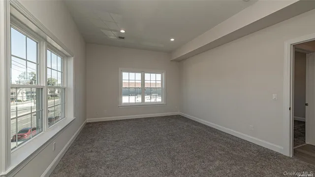 a bedroom with a large bed and a large window