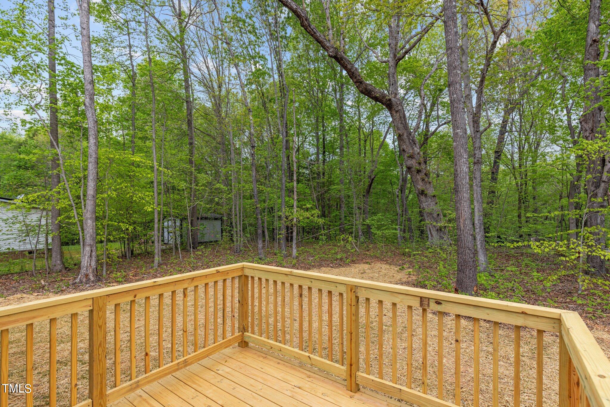 474 Street's Store Road Roxboro, NC 27574 - Photo 36 of 49 a view of a wooden deck next to a yard