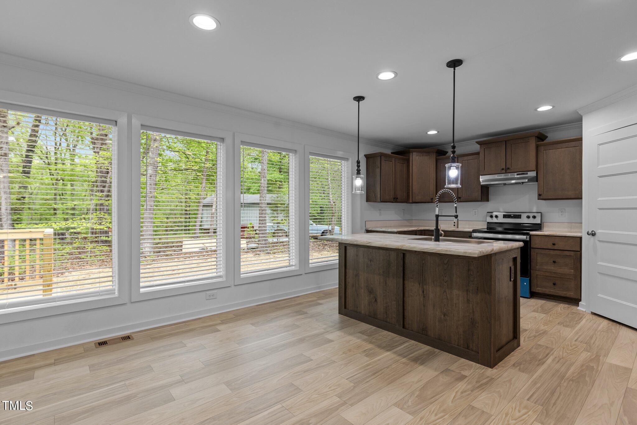 474 Street's Store Road Roxboro, NC 27574 - Photo 5 of 49 a large kitchen with kitchen island granite countertop a stove a sink a center island and a window