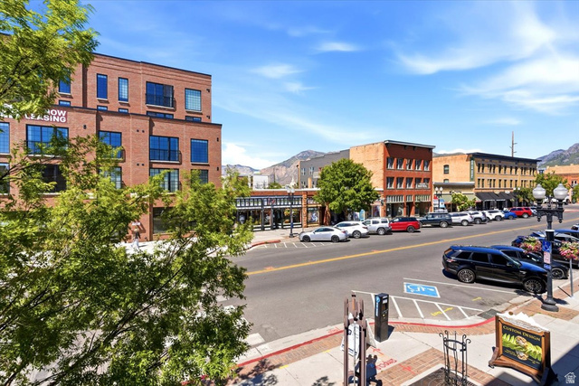 161 25th Street, Unit 6B Ogden, UT 84401 - Photo 19 of 20 Street-level perspective showcasing a vibrant commercial district with multi-story brick buildings