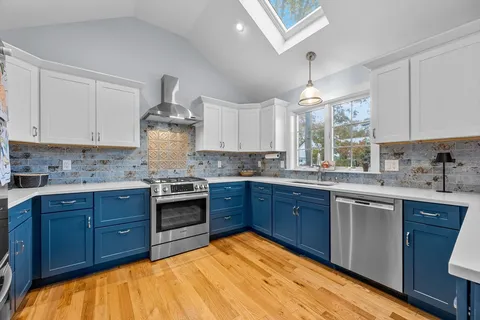 a kitchen with stainless steel appliances granite countertop wooden cabinets and a stove top oven