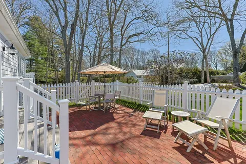 a view of a chair and tables in the patio