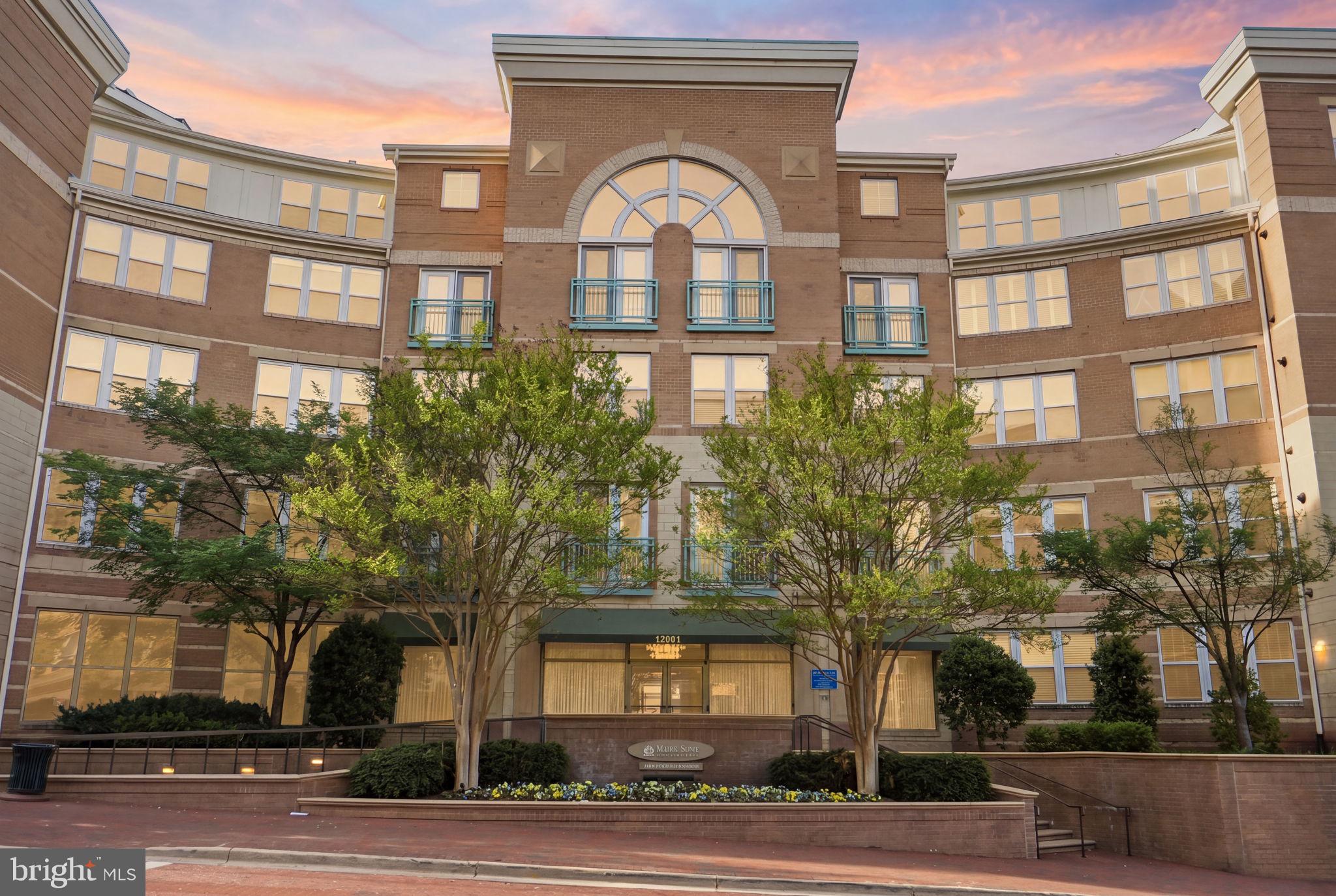 12001 Market Street, Unit 140 Reston, VA 20190 - Photo 48 of 48 Elegant brick facade at sunset.