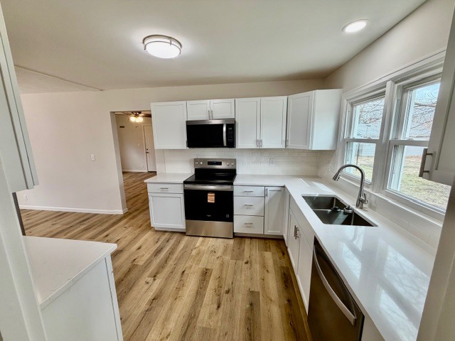 109 South Elm Street Lexington, IL 61753 - Photo 16 of 20 a kitchen with granite countertop a stove sink and cabinets
