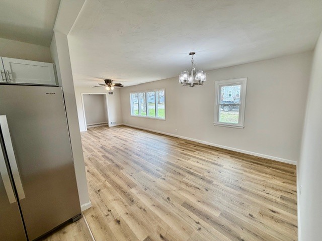 109 South Elm Street Lexington, IL 61753 - Photo 7 of 20 an empty room with wooden floor and windows