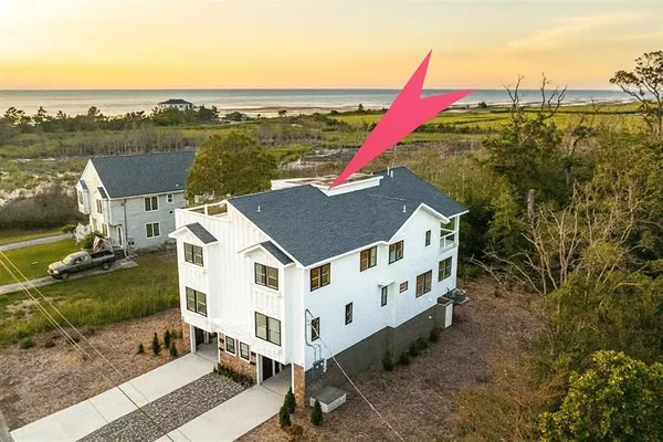 a view of a house with a yard and lake view