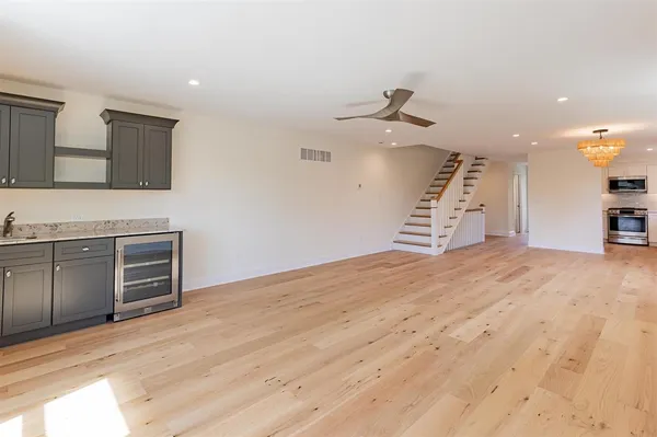 a view of a kitchen with microwave and a sink