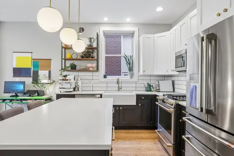 a kitchen with stainless steel appliances a sink stove and refrigerator
