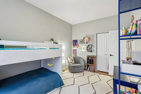 a bedroom with a bed and a book shelf