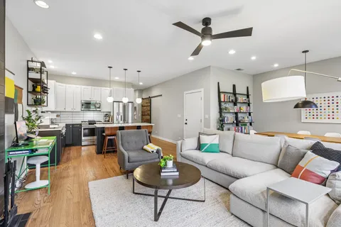 a living room with furniture kitchen view and a table