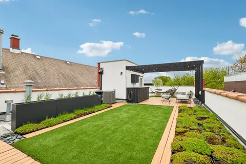 a view of a backyard with sitting area