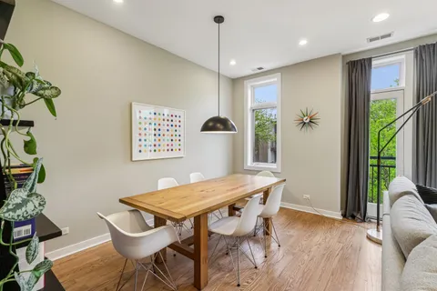 a view of a dining room with furniture window and wooden floor