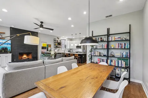 a living room with furniture a fireplace and a book shelf
