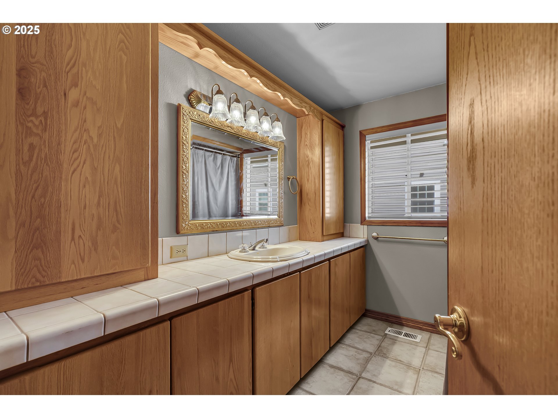 821 Bridge Street Vernonia, OR 97064 - Photo 25 of 45 a bathroom with a sink a mirror and a window