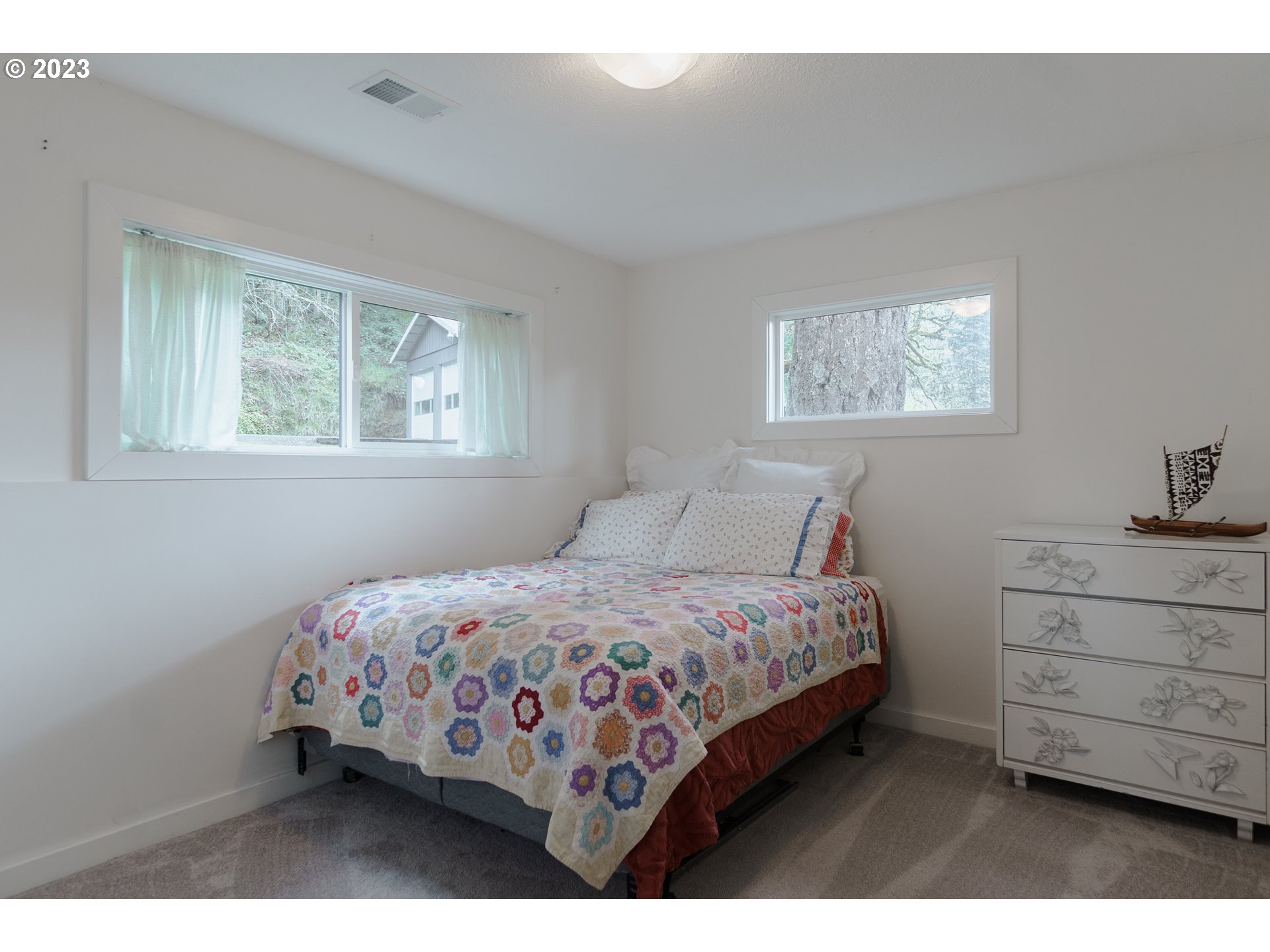 35243 McKenzie View Drive Springfield, OR 97478 - Photo 14 of 23 a bedroom with a bed and a dresser