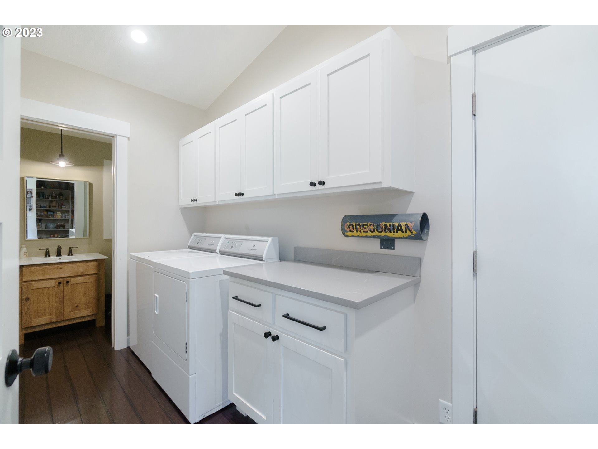 35243 McKenzie View Drive Springfield, OR 97478 - Photo 16 of 23 a utility room with cabinets washer and dryer