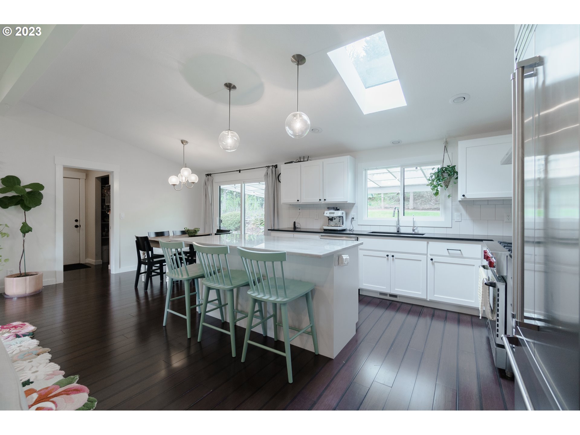 35243 McKenzie View Drive Springfield, OR 97478 - Photo 5 of 23 a kitchen with stainless steel appliances granite countertop a table chairs refrigerator and sink