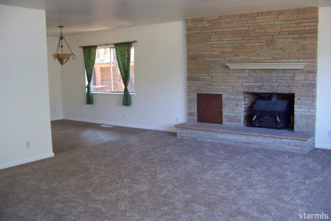 165 Pinion Road Markleeville, CA 96120 - Photo 2 of 34 an empty room with windows and fireplace