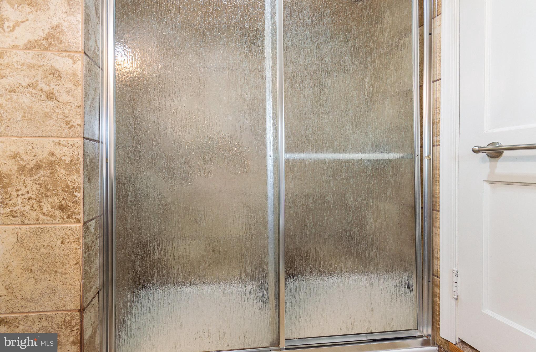 126 Prince George Street, Unit 4 Annapolis, MD 21401 - Photo 12 of 15 a bathroom with a glass shower door