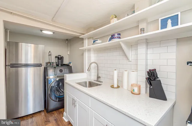 a kitchen with a refrigerator and a sink