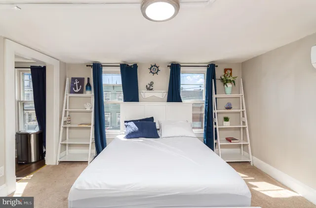 a bedroom with a large bed and a window