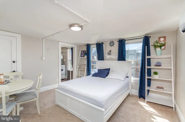 a bedroom with a bed and a table